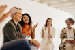 © Jacob Lund - Smiling businesswomen applauding their colleague in an office