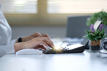 Poster - Woman accountant using calculator and laptop computer in office, businessman working at home, finance and accounting concept.