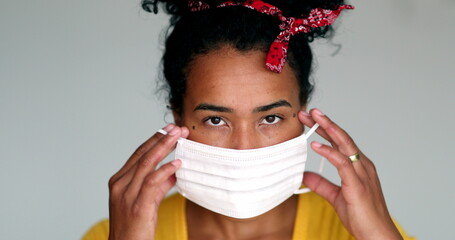 Wall Mural - Mixed race young black woman putting mask against virus