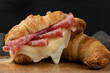 Close up on croissant stuffed with salami and cheese.