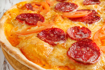 delicious hot traditional italian pizza on a white wooden rustic background