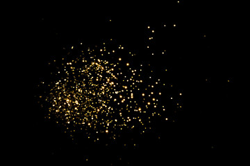 Golden blurred bokeh lights on black background. Glitter sparkle stars for celebrate. Overlay for your design