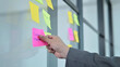 Man hand sticking paper on scrum task board, Stand-up meeting and Agile and scrum methodology concept