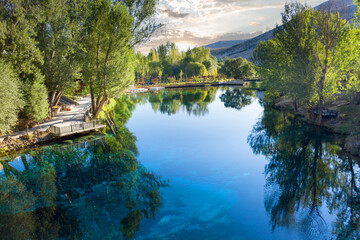 Wall Mural - Gorgeous Gökpınar pond with its clear turquoise water and underwater plants in green nature, Aerial view. Sivas - Gürün TURKEY