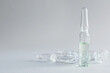 Pharmaceutical ampoules with medication on light grey background. Space for text