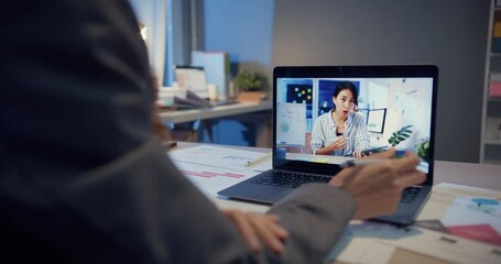 Wall Mural - Asia woman using laptop talk to colleagues about work in video call while working from home at living room at night. Self-isolation, social distancing, quarantine for coronavirus prevention.