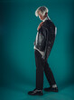 © qunica.com - Male beauty concept. Portrait of fashionable young man with stylish haircut wearing trendy glasses and sweater, posing over gray background. Perfect hair & skin. Hipster style. Copy-space. Studio shot