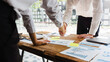 © Phushutter - Young start up businessman and woman shaking hands in the office working together as a team.