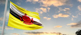 Fototapeta  - Brunei national flag cloth fabric waving on the sky - Image