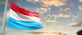 Fototapeta  - Luxembourg national flag cloth fabric waving on the sky - Image