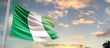 Nigeria national flag cloth fabric waving on the sky - Image