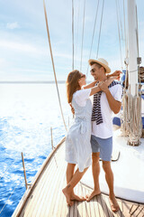 Wall Mural - Happy young couple resting on yacht