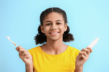 Sticker - African-American teenage girl with tooth brush and paste on blue background