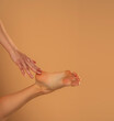 © vladimirfloyd - Perfect clean female feet . Beautiful and elegant groomed woman's hand touching her foot . Spa ,scrub and foot care