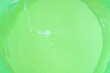 Close up surface of green gel cream (aloe vera gel) in plastic container, textured for background