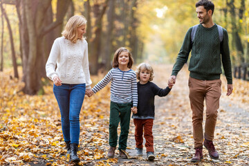 Wall Mural - Young family having fun outdoors
