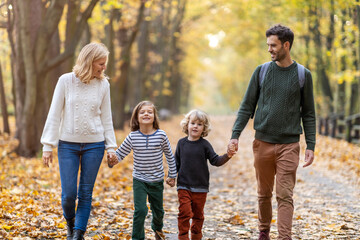 Wall Mural - Young family having fun outdoors
