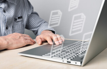Poster - Businessman using laptop for electronic documents, letters sending and receiving. Man sitting at desk with computer. Online communication and paper flow concept. High quality photo