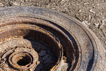 An Old Rusty Car Tire On The Ground
