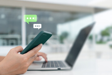 People hand using smartphone typing, chatting or text  messages in chat icons pop up. Social media maketing technology concept.