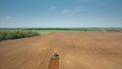 Wall Mural - 4K Aerial Flat View. Birds In Flock Following For Tractor That Plowing Field In Spring Season. Beginning Of Agricultural Spring Season. Cultivator Pulled By A Tractor In Countryside Rural Field