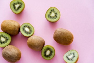 Wall Mural - top view of cut green kiwi on pink.