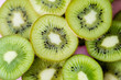 top view of sliced fresh kiwi on pink, close up.