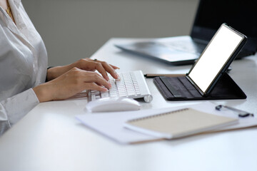 Poster - Closeup of a woman's hands typing on a computer keyboard, a businesswoman or a student at home using a laptop, online learning, internet marketing, working from home, office workspace, freelancing