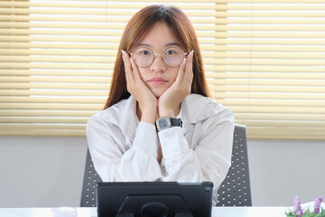 Sticker - Woman working from home on her laptop looked worried, exhausted, and overwhelmed.