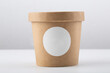 Brown crafted paper cup for soup on grey background. Eco package. Zero Waste. Mock up for branding.