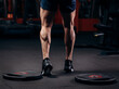 © VlaDee - Trained legs with muscular calves in sneakers in fitness training gym