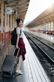 Summer, Travel, Vacation, Relax, A smiling female tourist looks at the train station for a summer vacation, travel concept