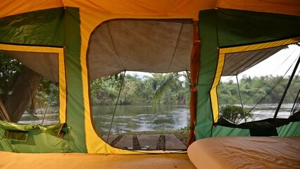 Wall Mural - Yellow tent pitch in campsite the forest at riverside