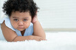 © Pruksachat - Portrait of little sad African American chubby kid girl is crying with tears rolled down her cheeks while lying on fluffy carpet on floor at home. Child emotion care concept. White background
