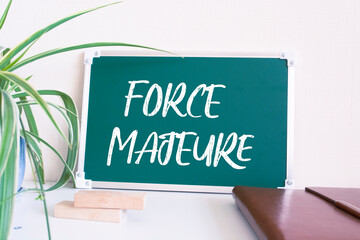 Wall Mural - Force Majeure text on blackboard