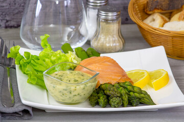 Wall Mural - delicious salmon with asparagus and sauce on white plate