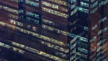 Windows In Office Building Exterior In The Late Evening With Interior Lights On Timelapse