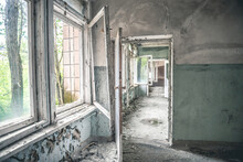 Gloomy Corridor With Broken Window Frames And Debris