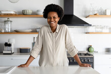 Portrait Of Smiling Mid Adult African American Woman Standing In Kitchen At Home