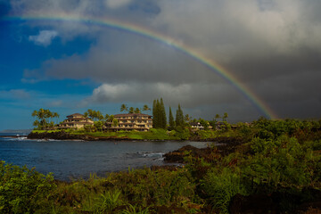 Wall Mural - 2022-05-06 THE SHORELINE ON THE ISLAND OF KAUAI WITH DARK CLOUDS AND A NICE RAINBOW IN A BEAUTIFUL INLET