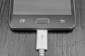 Phone photos charging on a gray background.