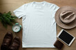 Mockup of a white t-shirt blank shirt template with accessories on the wooden table background, lifestyle and travel concept