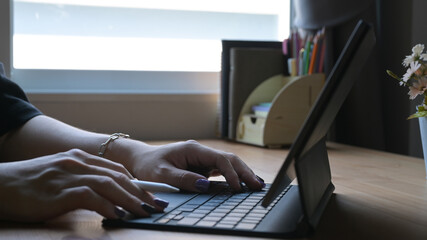 Wall Mural - Man hands typing on wireless keyboard go digital tablet. Cropped shot.