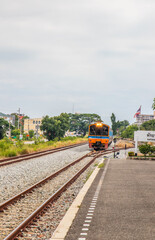 Poster - A train pulls into a station and waits for passengers