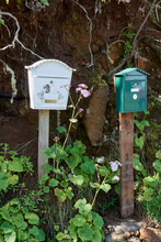 Vertical Shot Of Two Mailboxes On Wooden Poles In La Palma, Canary Islands