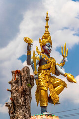 Sticker - Vertical closeup of a deity statue in a buddhist temple in Thailand.