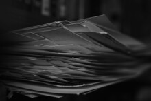 Greyscale Shot Of Stacked Papers