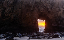 Telephoto Shot Of The Keyhole Arch, With The Sun Peeking Trough.
