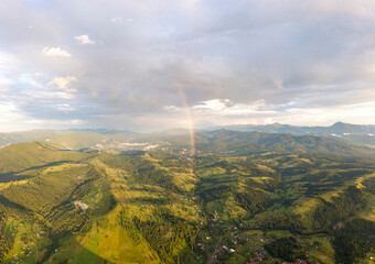 Wall Mural - Aerial drone view. Rainbow in the mountains of the Ukrainian Carpathians.