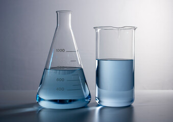 beaker next to a test tube with blue liquid